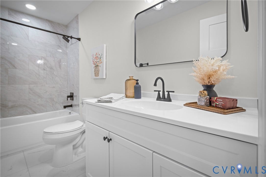 2211 Royall Avenue, Bellemeade, Richmond, VA 23224 White vanity with a white countertop, black faucet, and rectangular mirror