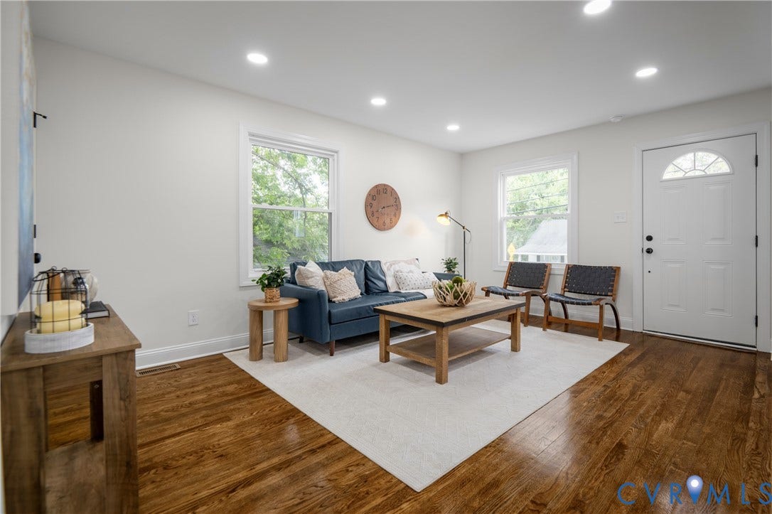 2211 Royall Avenue, Bellemeade, Richmond, VA 23224 Recessed lighting, wood-finish flooring, white paneled door with arched glass detail, two windows with white trim, and a built-in media console