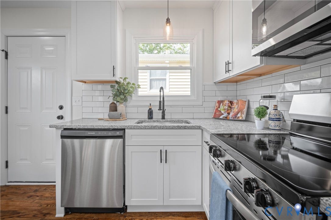 2211 Royall Avenue, Bellemeade, Richmond, VA 23224 White shaker-style cabinetry, stainless steel dishwasher, speckled countertops, white subway tile backsplash, and wood-finish flooring