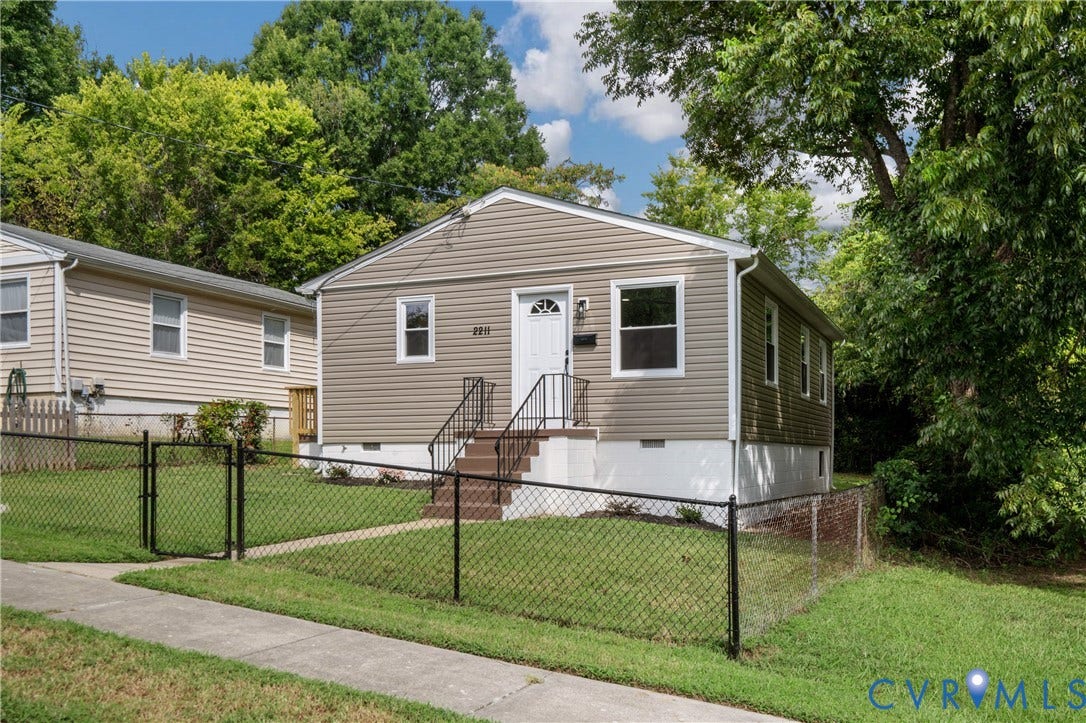 2211 Royall Avenue, Bellemeade, Richmond, VA 23224 Fiber cement siding exterior with a white entry door, front porch with black railings, and black chain-link fencing
