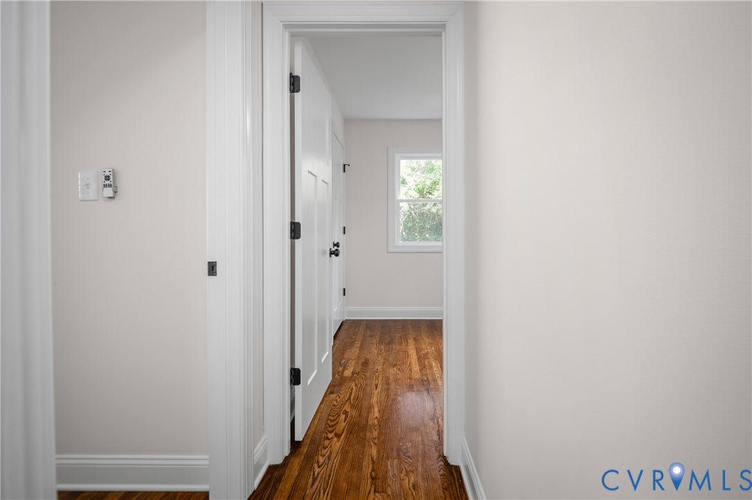 2211 Royall Avenue, Bellemeade, Richmond, VA 23224 Hardwood flooring, white trim, white interior doors, and a window providing natural light