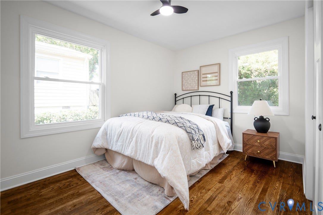 2211 Royall Avenue, Bellemeade, Richmond, VA 23224 Hardwood flooring, white painted walls, white trim, two windows with white frames, and a ceiling fan