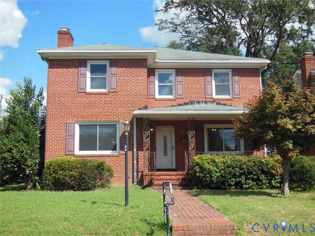 2203 Seminary Avenue, Richmond, VA 23220 Brick faade with a covered porch, an arched entry door, and a brick pathway