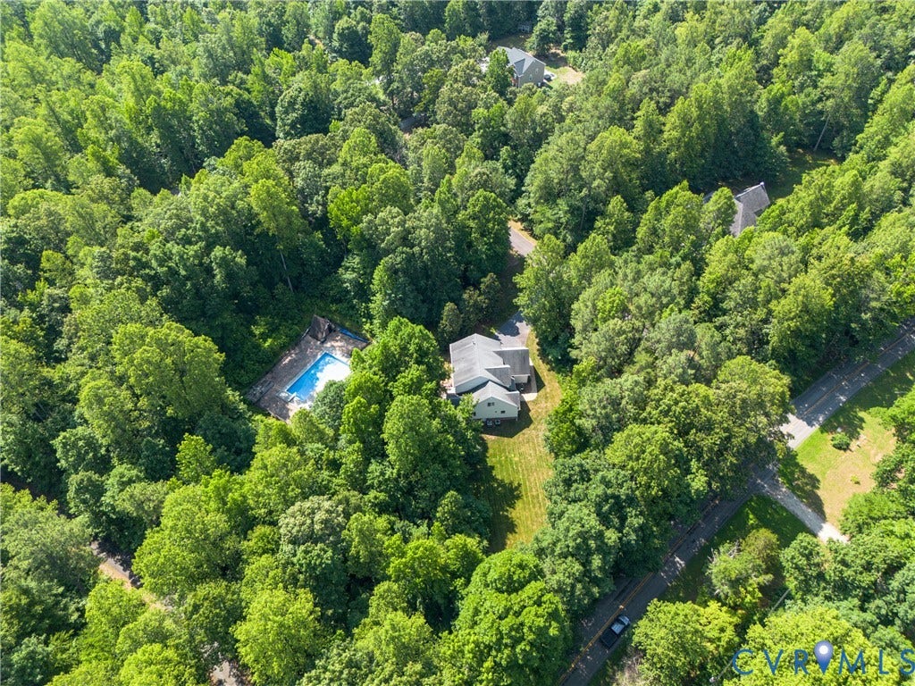 Expansive property with mature trees, a private swimming pool, and substantial natural landscaping