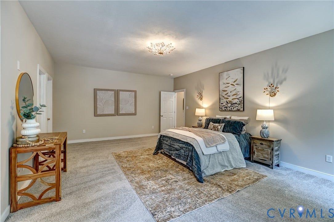 Carpeted flooring throughout, vaulted ceiling, and recessed lighting