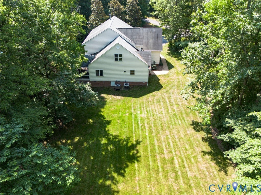 Expansive green lawn with mature perimeter trees