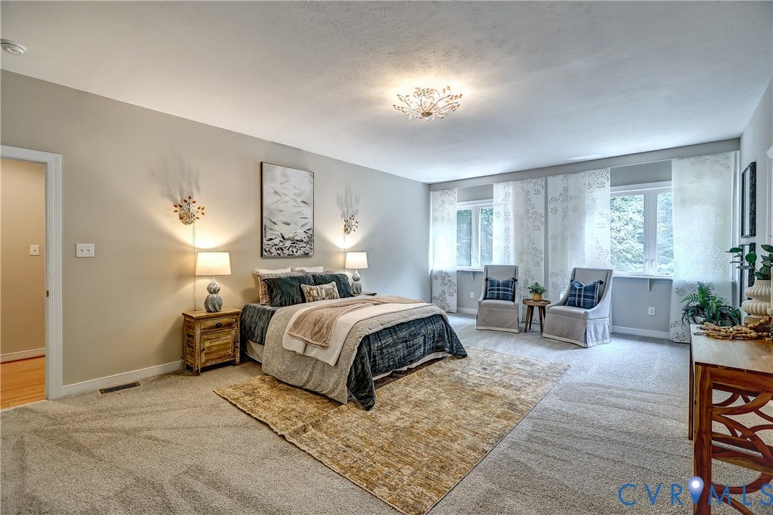 Spacious room with light neutral wall tones, multiple windows, and recessed lighting