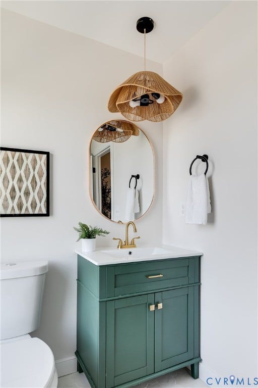 404 W 31st Street, Woodland Heights, Richmond, VA 23225 White vanity with an integrated sink, gold-finish faucet, and coordinating hardware