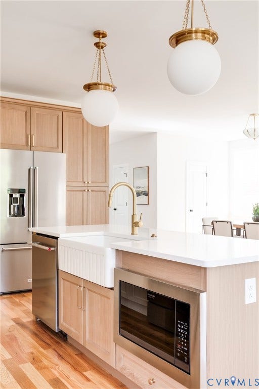 404 W 31st Street, Woodland Heights, Richmond, VA 23225 Kitchen island with a built-in microwave, white farmhouse sink, and a brushed gold faucet