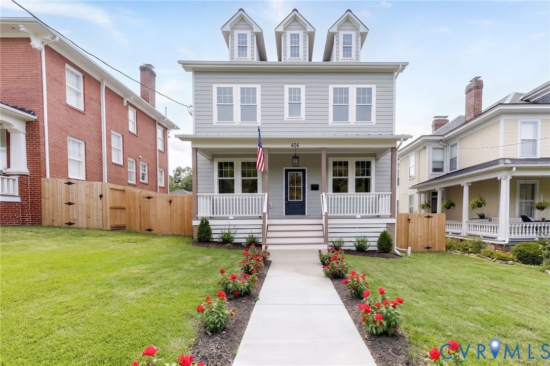 404 W 31st Street, Woodland Heights, Richmond, VA 23225 Siding exterior with dormer windows, a covered front porch, and a concrete pathway flanked by manicured landscaping