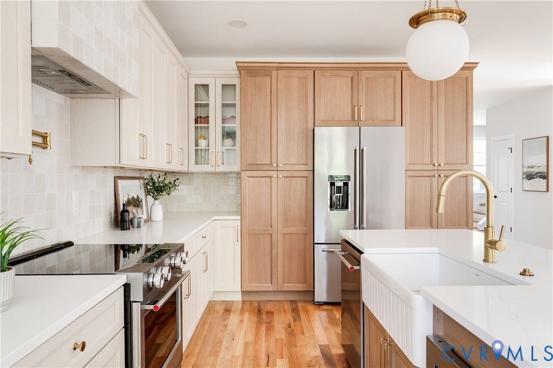 404 W 31st Street, Woodland Heights, Richmond, VA 23225 Stainless steel appliances, wood-finish flooring, white countertops, farmhouse sink, and mixed-tone cabinetry