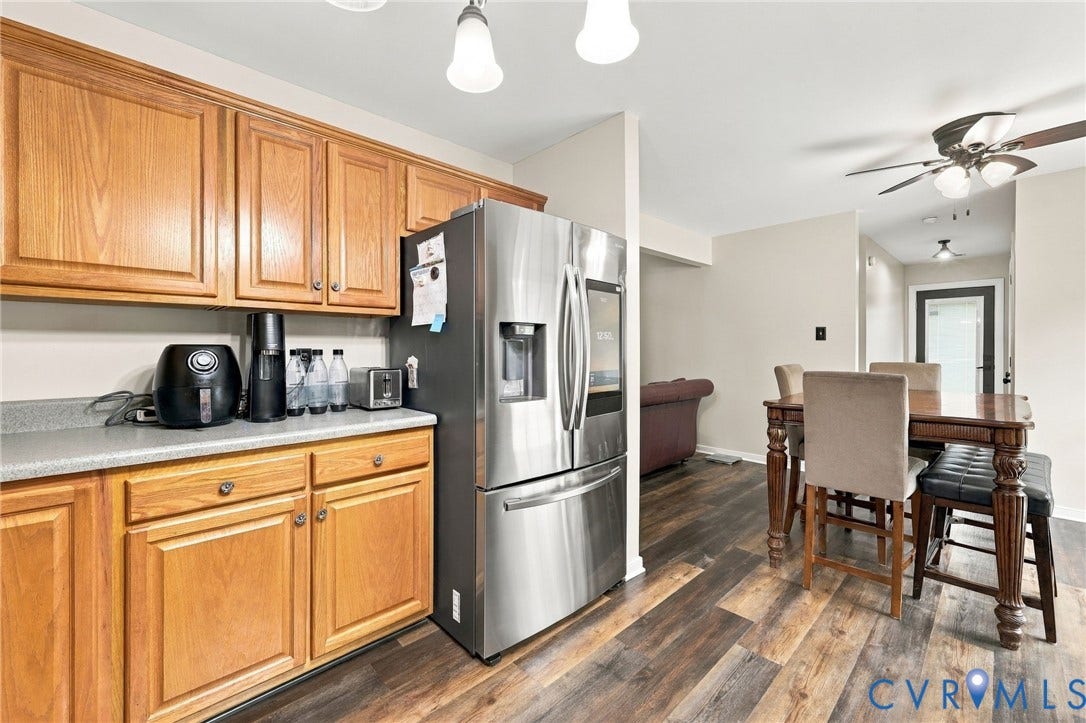 133 Ford Road, Bumpass, VA 23024 Wood-finish flooring, wood cabinetry, light countertops, and a stainless steel refrigerator