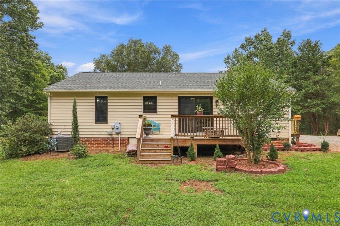 133 Ford Road, Bumpass, VA 23024 Rear exterior featuring a wood deck, brick foundation, and horizontal siding
