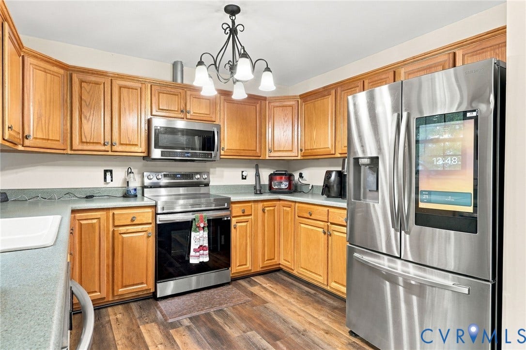 133 Ford Road, Bumpass, VA 23024 Wood-finish flooring, stainless steel appliances, wood cabinetry, and a built-in microwave