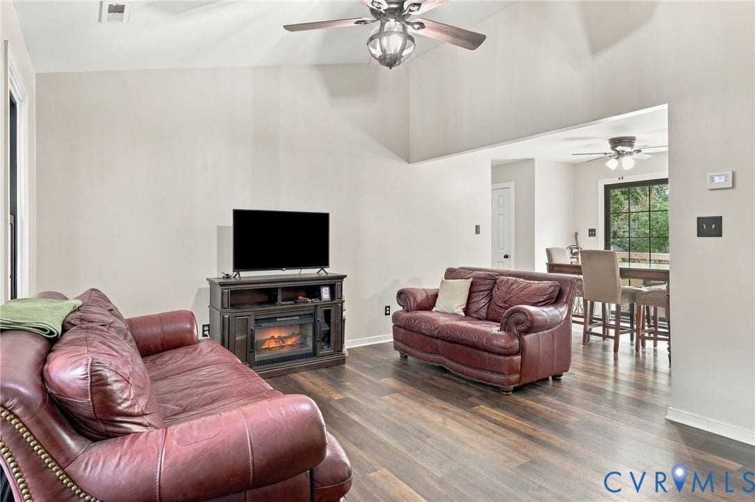 133 Ford Road, Bumpass, VA 23024 Vaulted ceilings, wood-finish flooring, and built-in electric fireplace media console