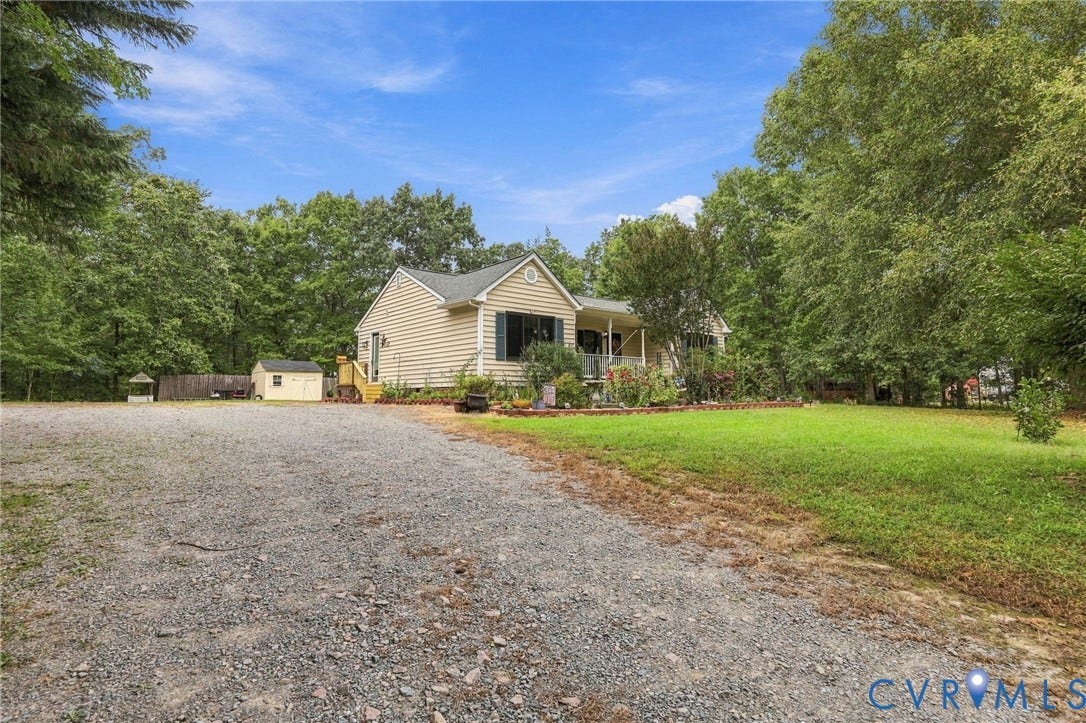 133 Ford Road, Bumpass, VA 23024 Gravel driveway with a detached shed, mature trees, and a covered front porch