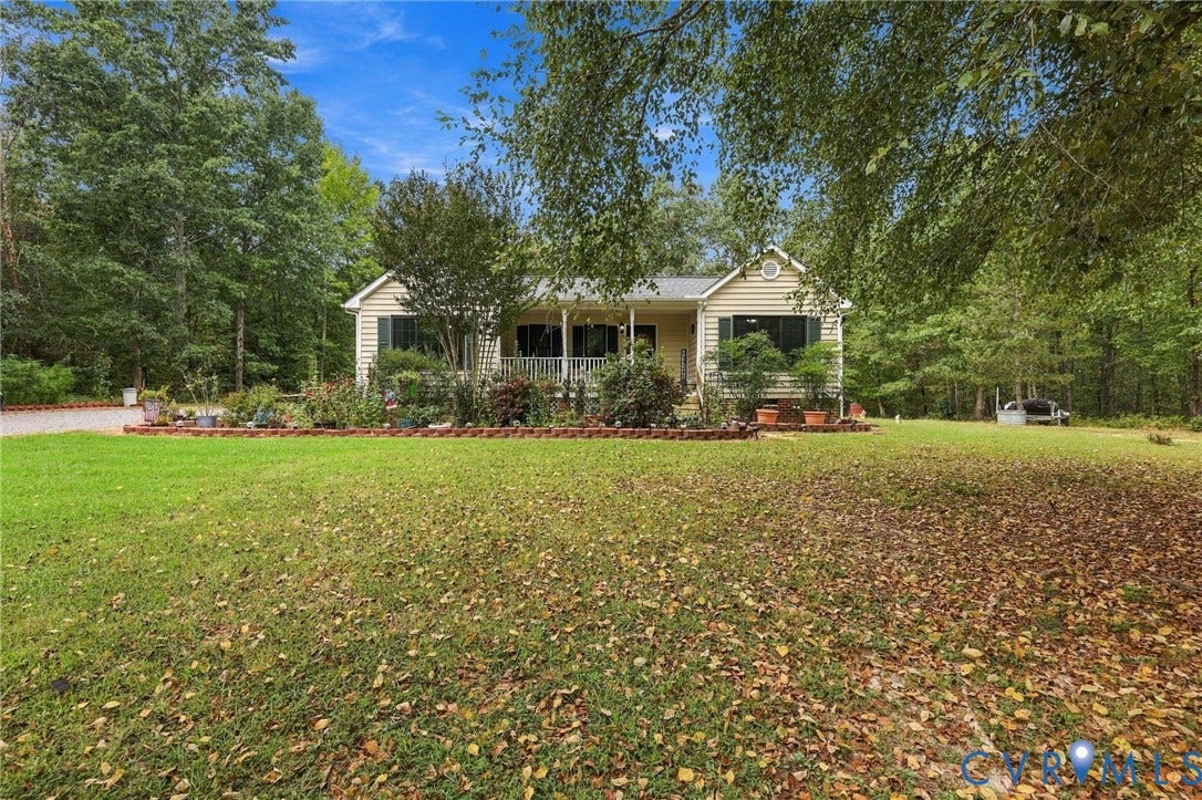 133 Ford Road, Bumpass, VA 23024 Siding exterior with a covered front porch, white porch railing, and dormer window