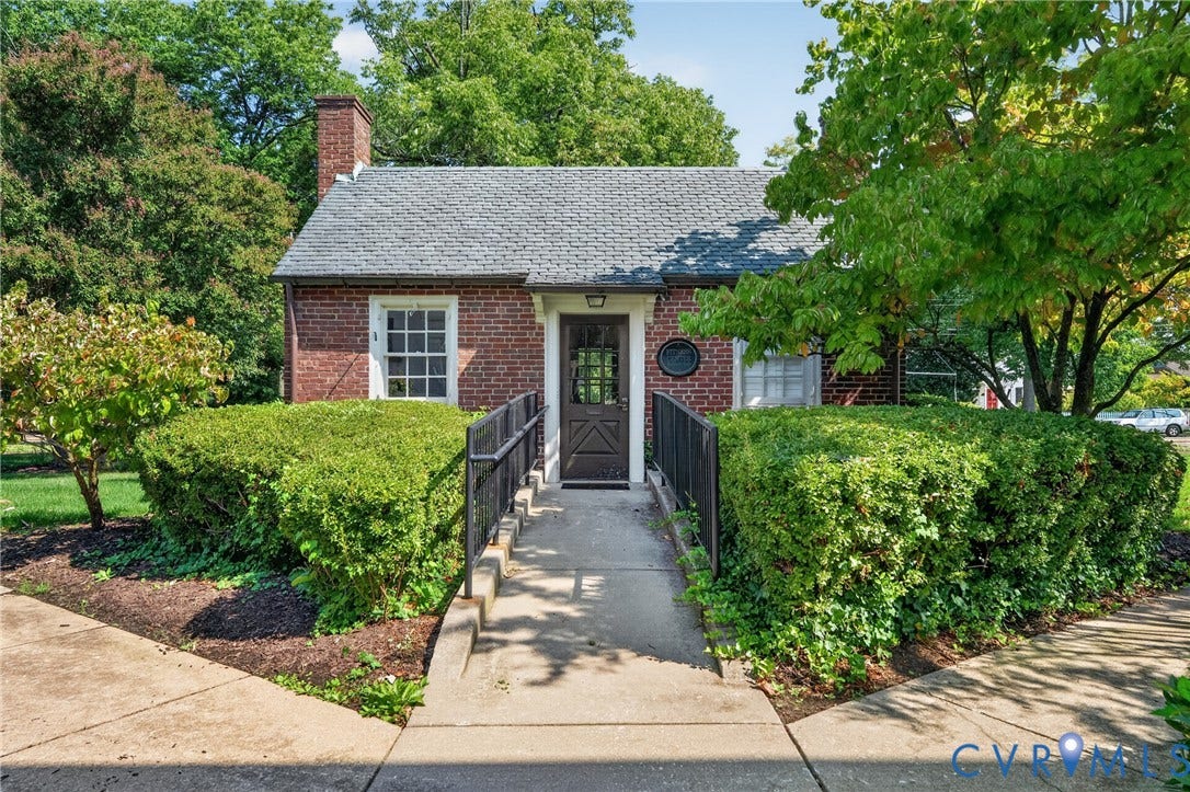 Brick exterior with a gabled roof and prominent chimney