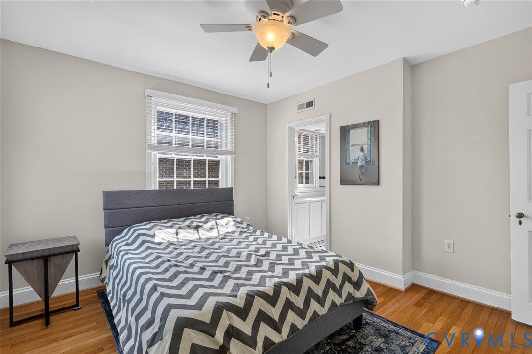 Hardwood flooring, painted walls, ceiling fan with integrated lighting, window with blinds, and white trim throughout