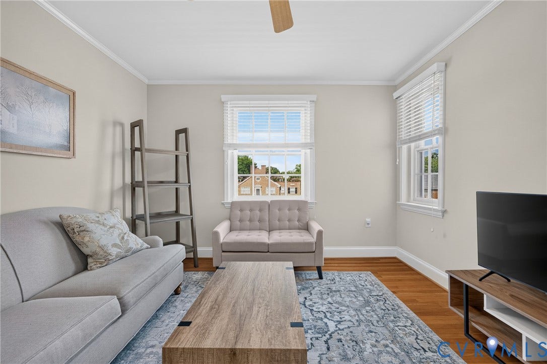 Hardwood flooring, multiple windows with blinds, crown molding, and a ceiling fan