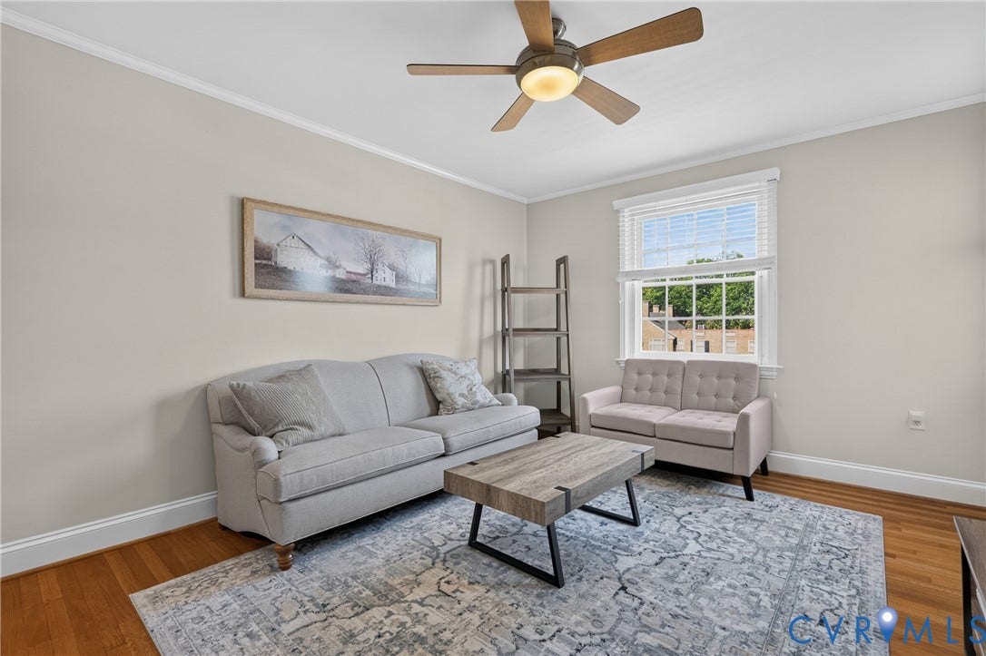 Hardwood flooring, painted walls, crown molding, a ceiling fan with integrated lighting, and a window with blinds
