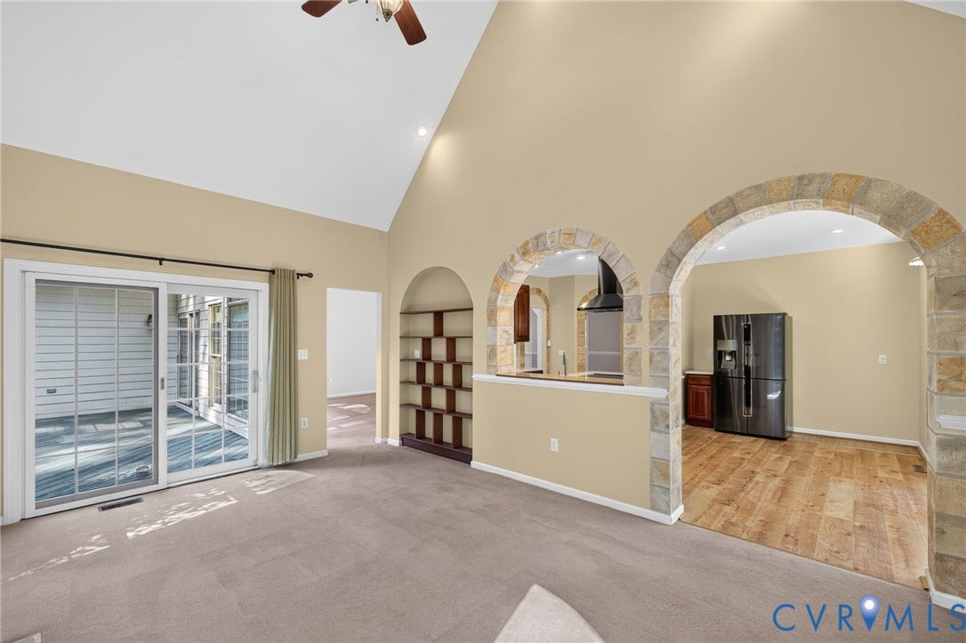 365 Hamlet Road, Manakin Sabot, VA 23103 Vaulted ceiling with a ceiling fan, stone archways, built-in shelving, sliding glass doors, and wood-finish flooring