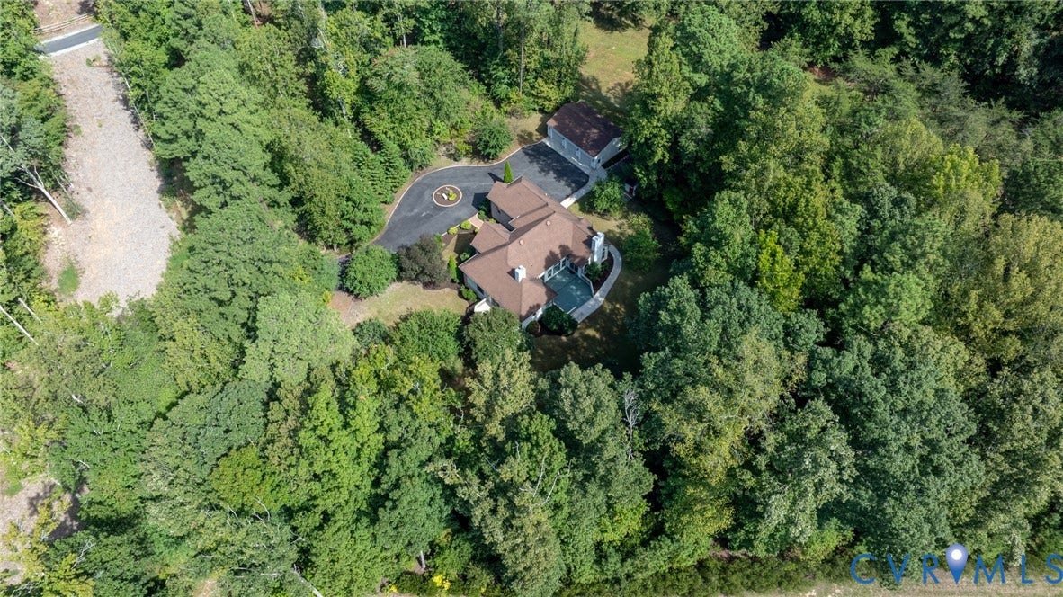 365 Hamlet Road, Manakin Sabot, VA 23103 Expansive property nestled within mature trees featuring a helipad, paved circular driveway, and a multi-level deck