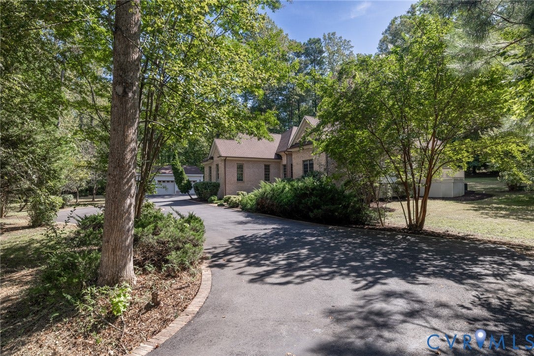 365 Hamlet Road, Manakin Sabot, VA 23103 Paved driveway with brick edging, mature trees, established landscaping, and a brick-sided residence with a gabled roof