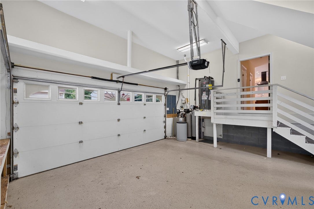 365 Hamlet Road, Manakin Sabot, VA 23103 Attached garage with vaulted ceiling, concrete flooring, and a white paneled garage door with upper window inserts