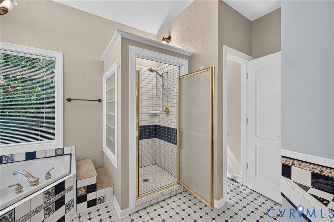 365 Hamlet Road, Manakin Sabot, VA 23103 Walk-in shower with clear glass enclosure and gold-toned hardware, adjacent to a built-in tub with decorative tile surround