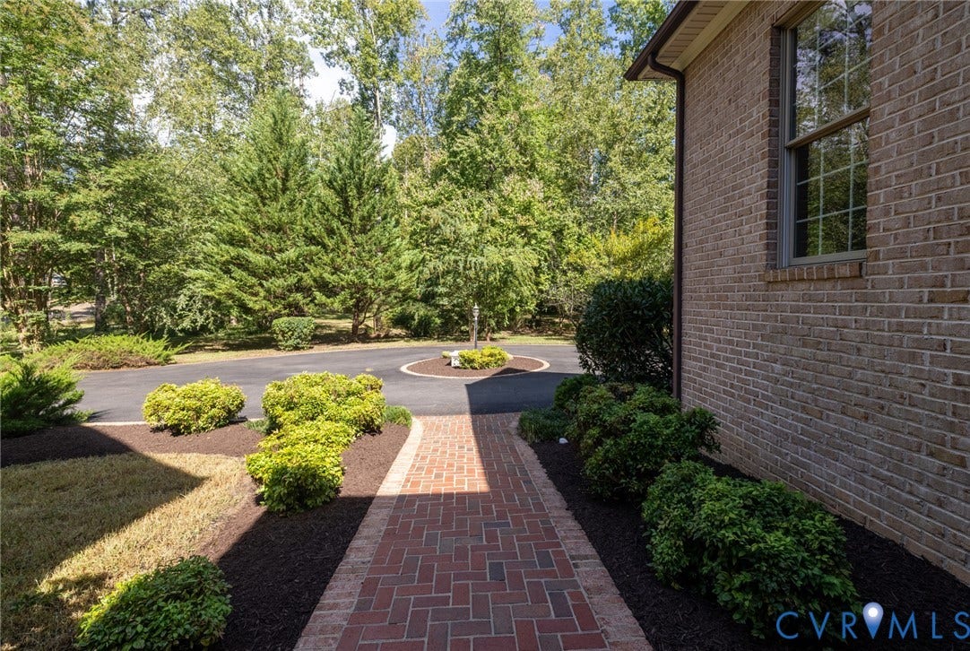 365 Hamlet Road, Manakin Sabot, VA 23103 Brick exterior with a large window, a brick pathway, mature landscaping, and an asphalt circular drive