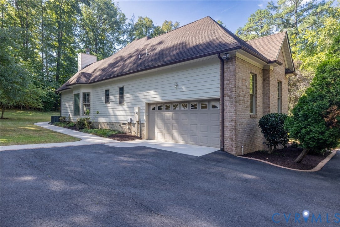 365 Hamlet Road, Manakin Sabot, VA 23103 Paved driveway with a two-car garage, brick exterior accents, and mature landscaping