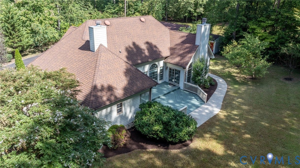 365 Hamlet Road, Manakin Sabot, VA 23103 Expansive backyard with a large deck, mature trees, and a concrete pathway