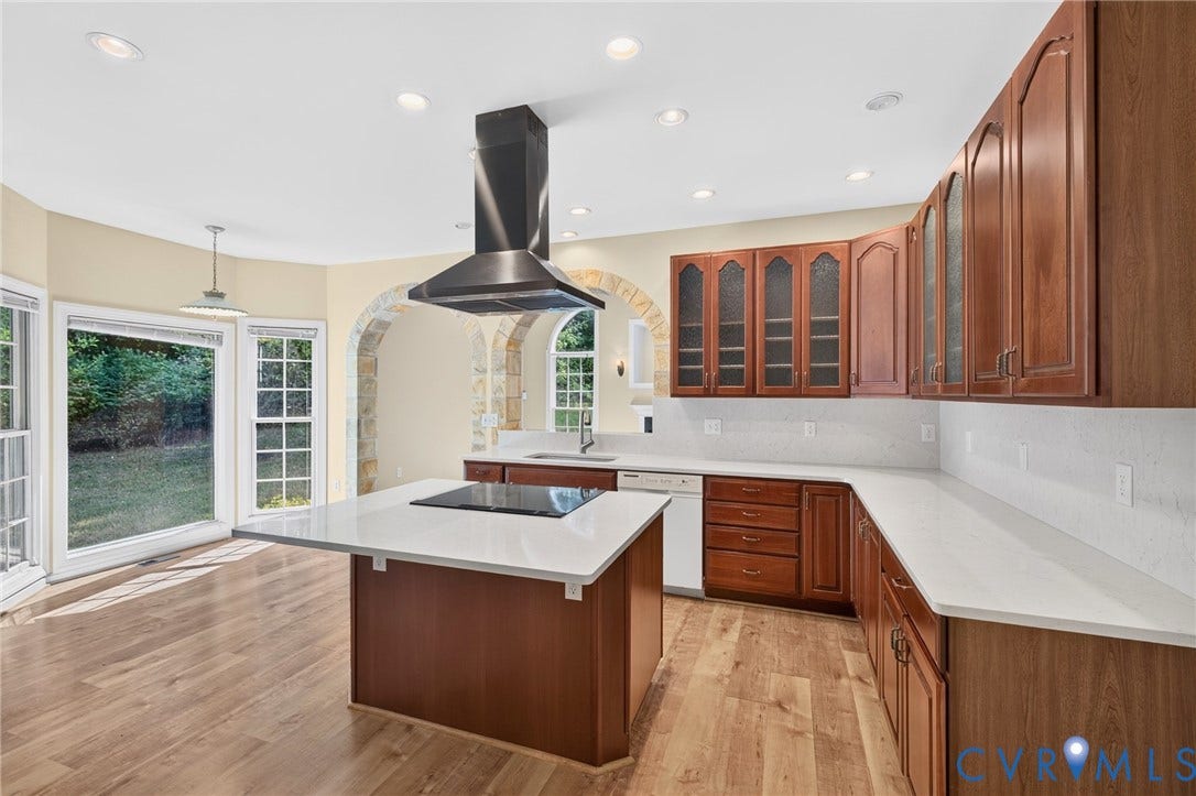 365 Hamlet Road, Manakin Sabot, VA 23103 Kitchen featuring wood-finish flooring, wood cabinetry with upper glass-front doors, white countertops, a central island with an integrated cooktop, and a stainless steel range hood