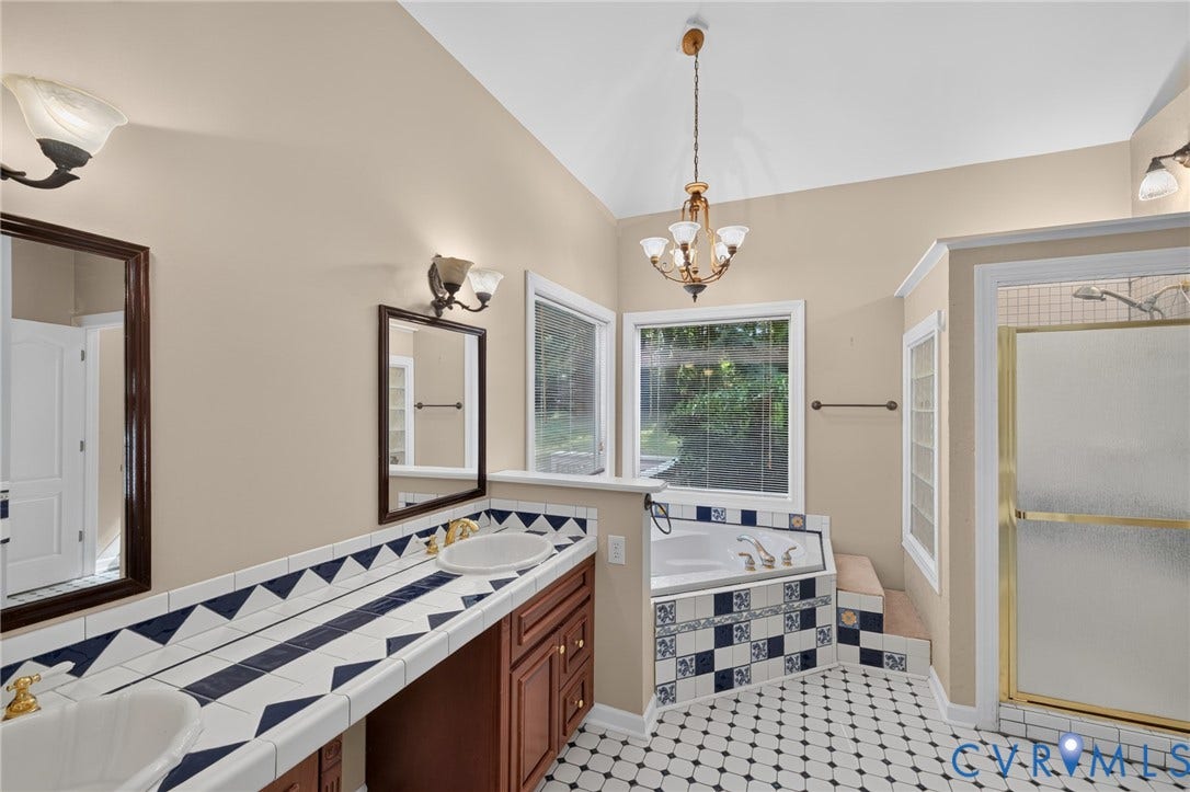 365 Hamlet Road, Manakin Sabot, VA 23103 Bathroom featuring tile flooring, a built-in soaking tub, a walk-in shower with a glass enclosure, a dual vanity with tile countertops, and a decorative chandelier