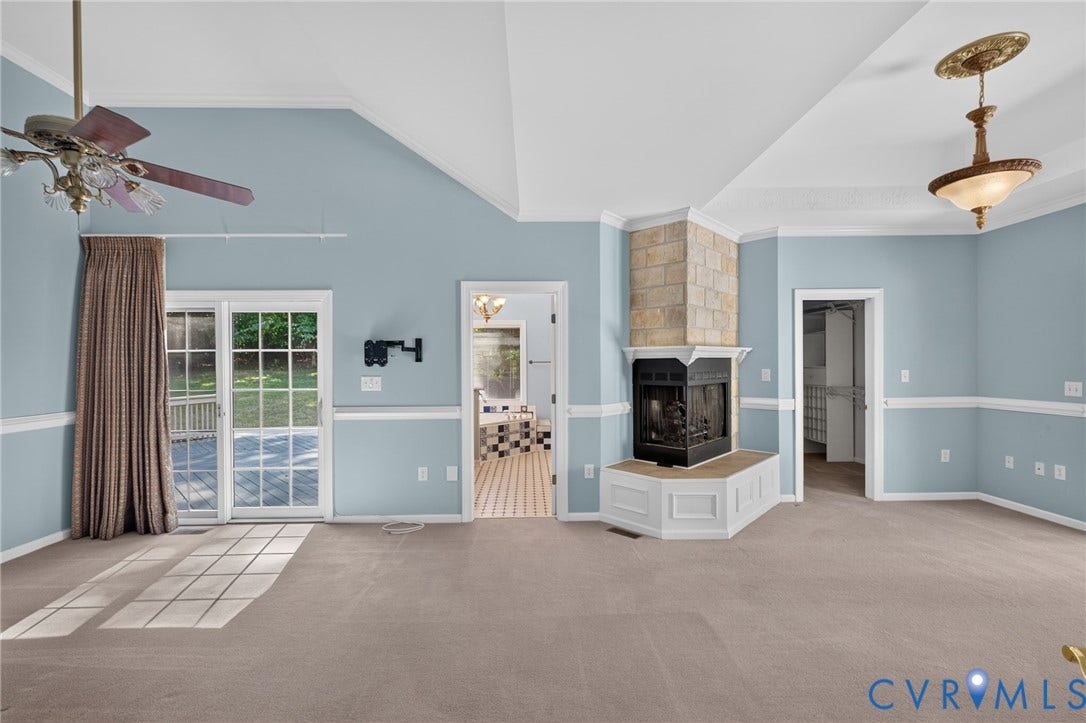 365 Hamlet Road, Manakin Sabot, VA 23103 Vaulted ceiling with a ceiling fan, stone-clad fireplace, and sliding glass doors to the exterior