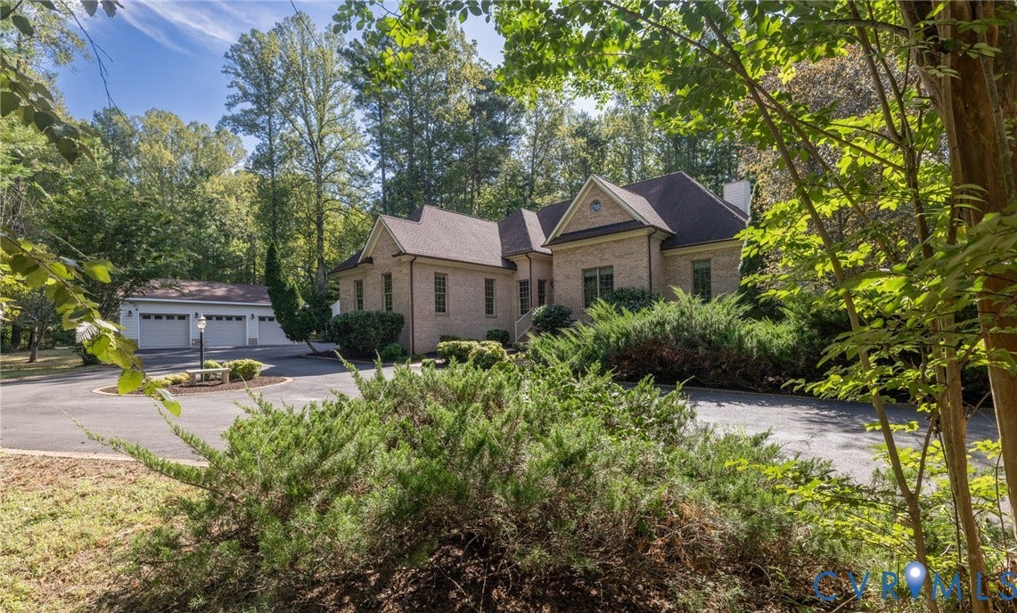 365 Hamlet Road, Manakin Sabot, VA 23103 Brick exterior residence with a multi-car garage, mature landscaping, and a paved circular drive