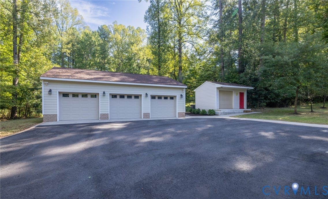 365 Hamlet Road, Manakin Sabot, VA 23103 Three-car garage with individual door access and stone veneer accents