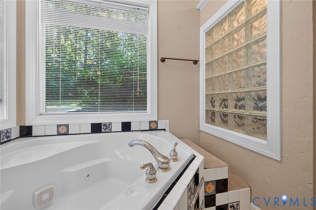 365 Hamlet Road, Manakin Sabot, VA 23103 Built-in soaking tub with chrome fixtures, tiled surround with decorative accents, and a large bay window