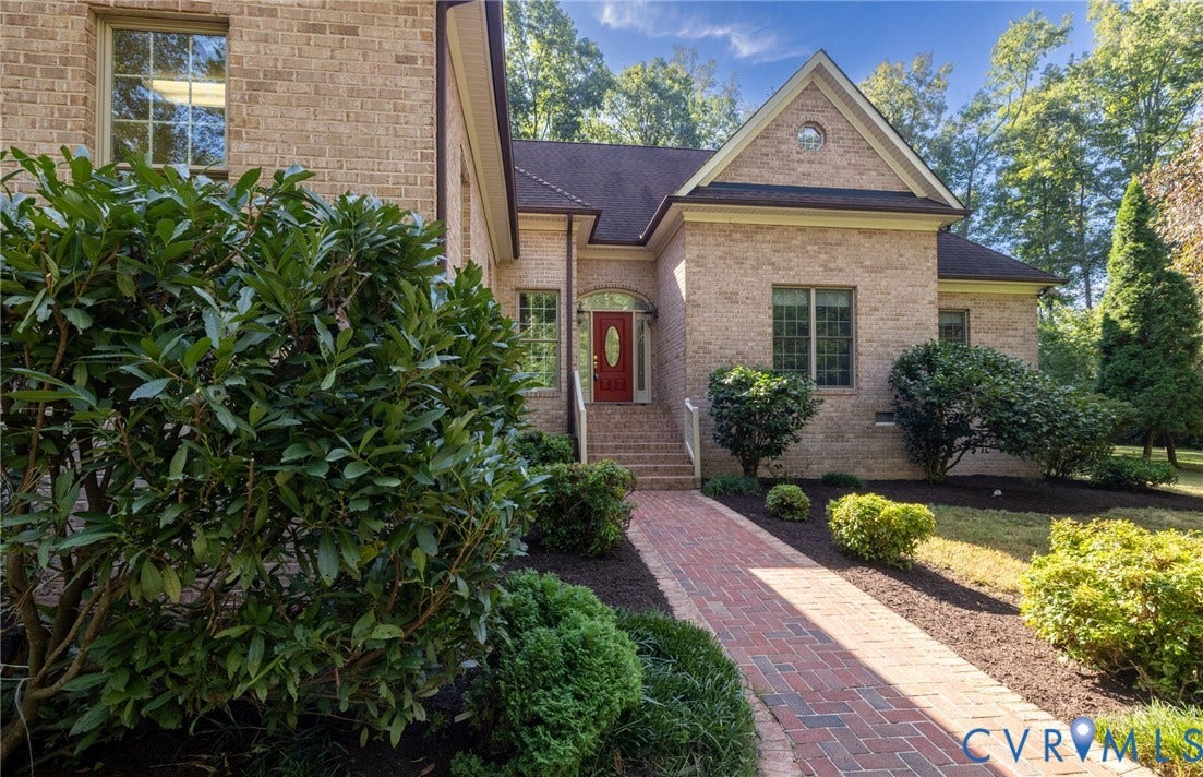 365 Hamlet Road, Manakin Sabot, VA 23103 Brick exterior with a gabled roofline, a red front door, and a brick paver walkway