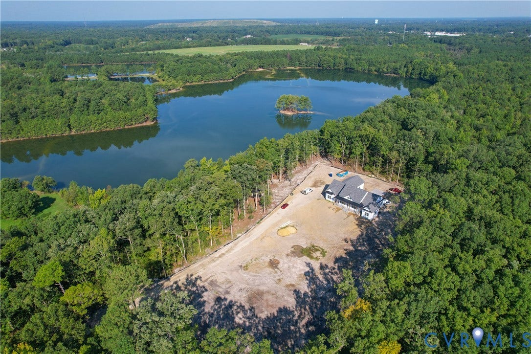 13216 Bradley Bridge Road, Chester, VA 23831 Waterfront property with a modern residential structure, surrounded by dense mature trees