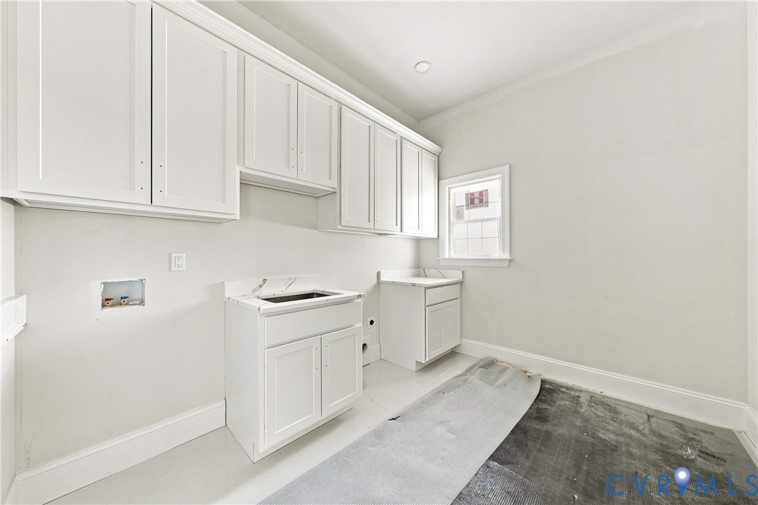 13216 Bradley Bridge Road, Chester, VA 23831 White upper cabinetry, lower cabinetry, and a utility sink