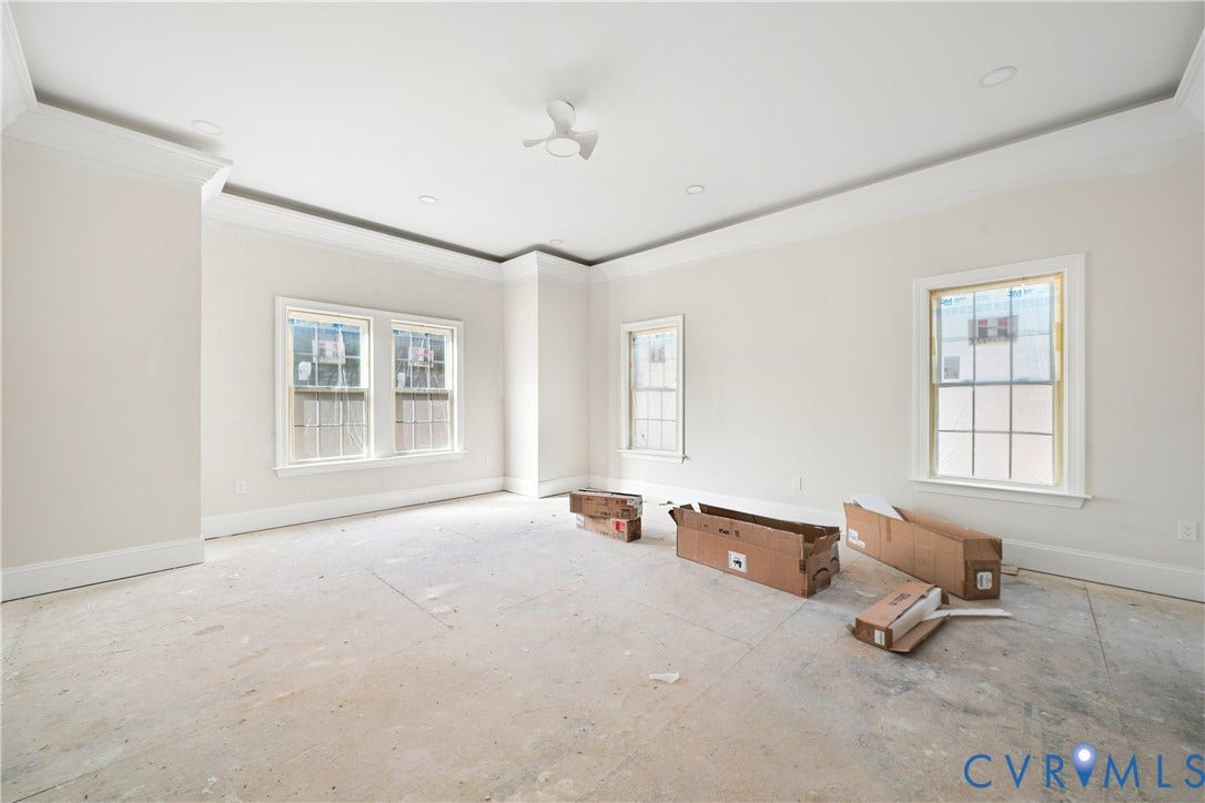 13216 Bradley Bridge Road, Chester, VA 23831 Tray ceiling with recessed lighting and a ceiling fan, multiple windows with grid panes, and crisp white wall paint