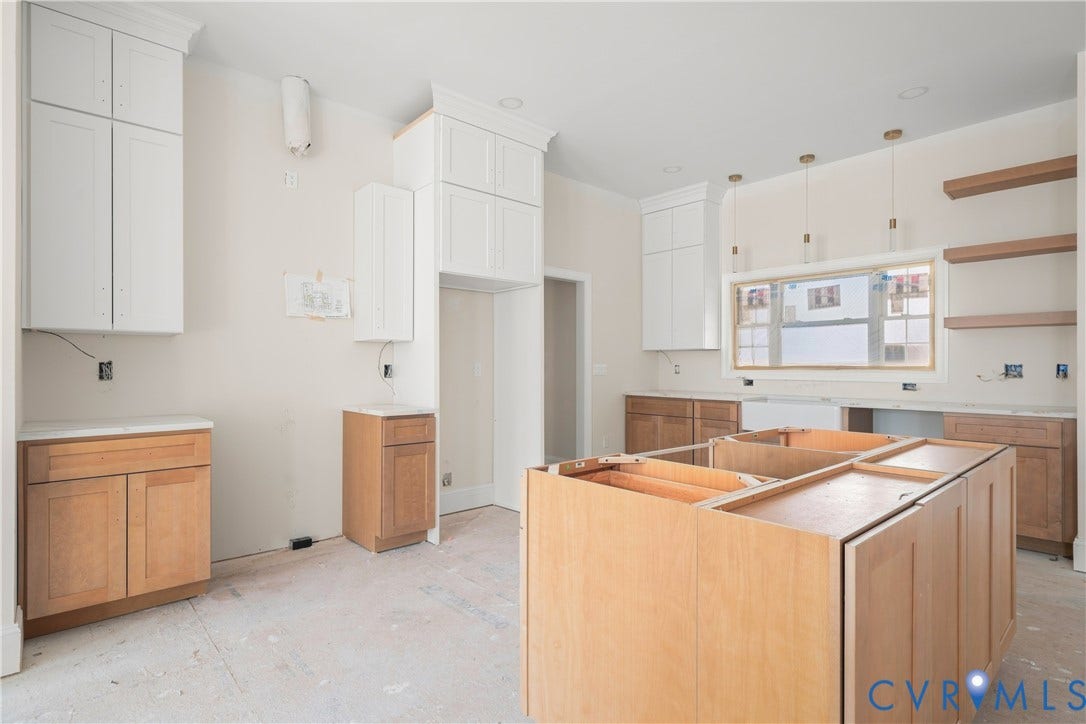 13216 Bradley Bridge Road, Chester, VA 23831 Kitchen featuring a center island, white upper cabinetry, natural wood-finish lower cabinetry, pendant lighting, and open shelving