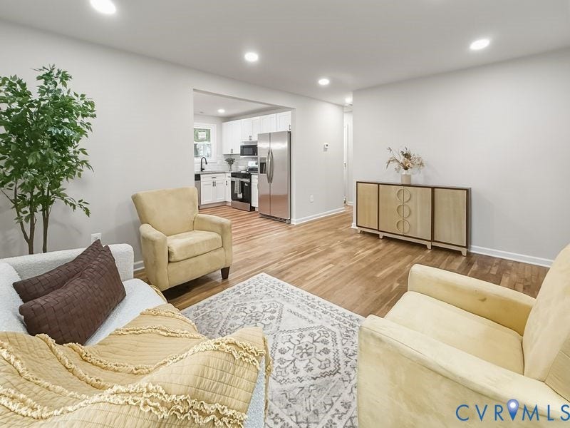 Recessed ceiling lighting, light wood-finish flooring, and white painted walls