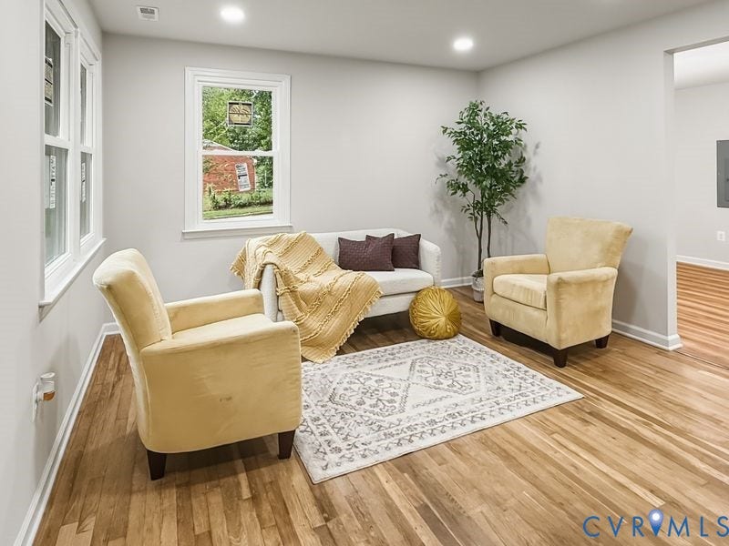 Recessed lighting, light gray wall paint, wood-finish flooring, and white trim