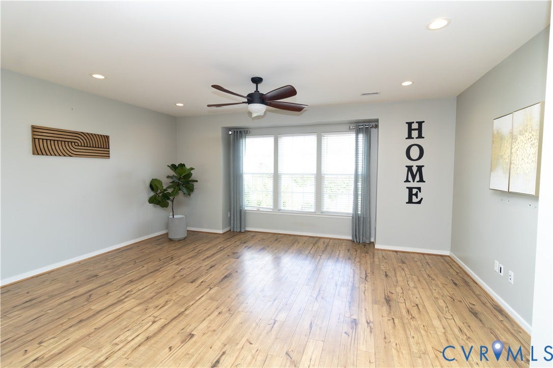 Wood-finish flooring, recessed lighting, and a ceiling fan with integrated lighting