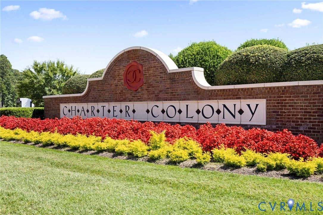 14119 Shawhan Place, Charter Colony, Midlothian, VA 23114 Brick sign with a decorative crest, white letter panels, and layered landscaping featuring red and yellow shrubbery