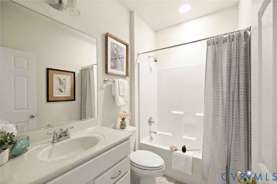 14119 Shawhan Place, Charter Colony, Midlothian, VA 23114 Full bathroom featuring a single vanity with an integrated sink, a large wall-mounted mirror, a toilet, and a combined tub and shower with a chrome fixture