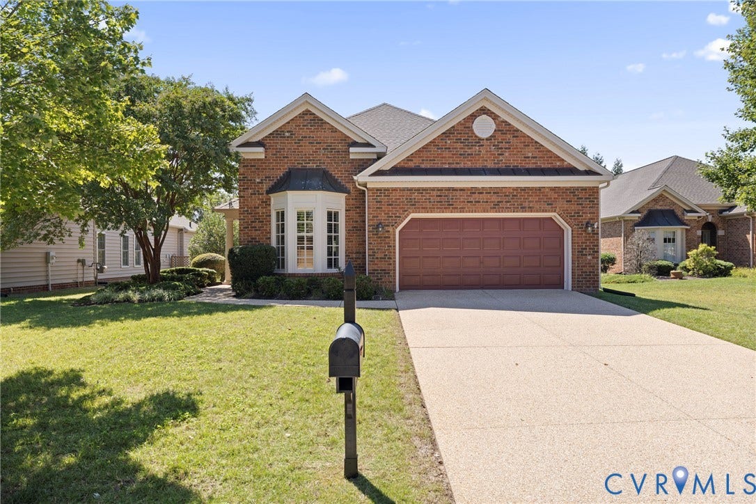 14119 Shawhan Place, Charter Colony, Midlothian, VA 23114 Brick exterior with a prominent bay window, attached garage, and a textured concrete driveway